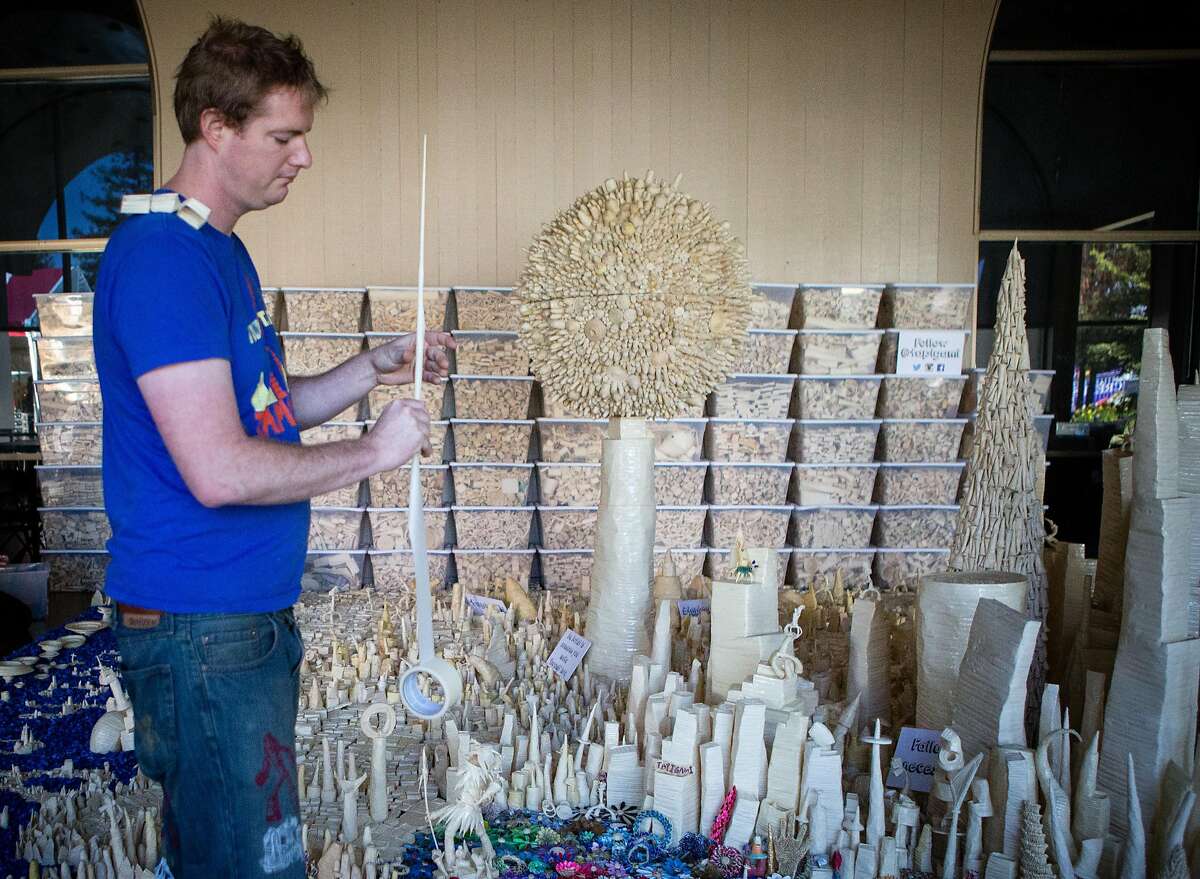 Maker Danny Scheible puts the final touches on "Tape-polis", an 11 year project made completely out of masking tape, a process that he calls "tapigami" at the San Mateo Event Center for Maker Faire on Thursday, May 19, 2016.