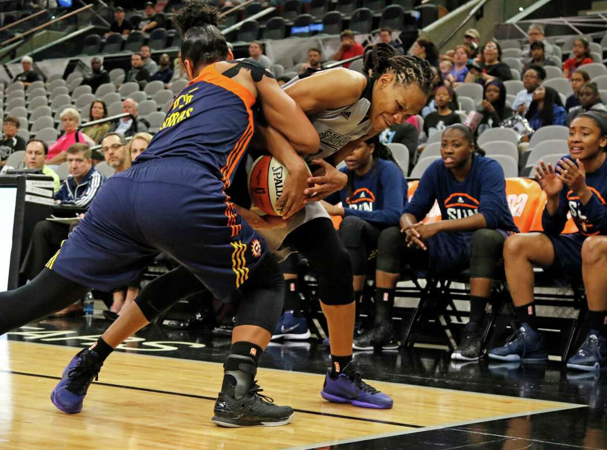 San Antonio Stars Monique Currie tries to wrestle away the ball from Connecticut Alyssa Thomas (left) in first half action at AT&T Center on May 18, 2016.