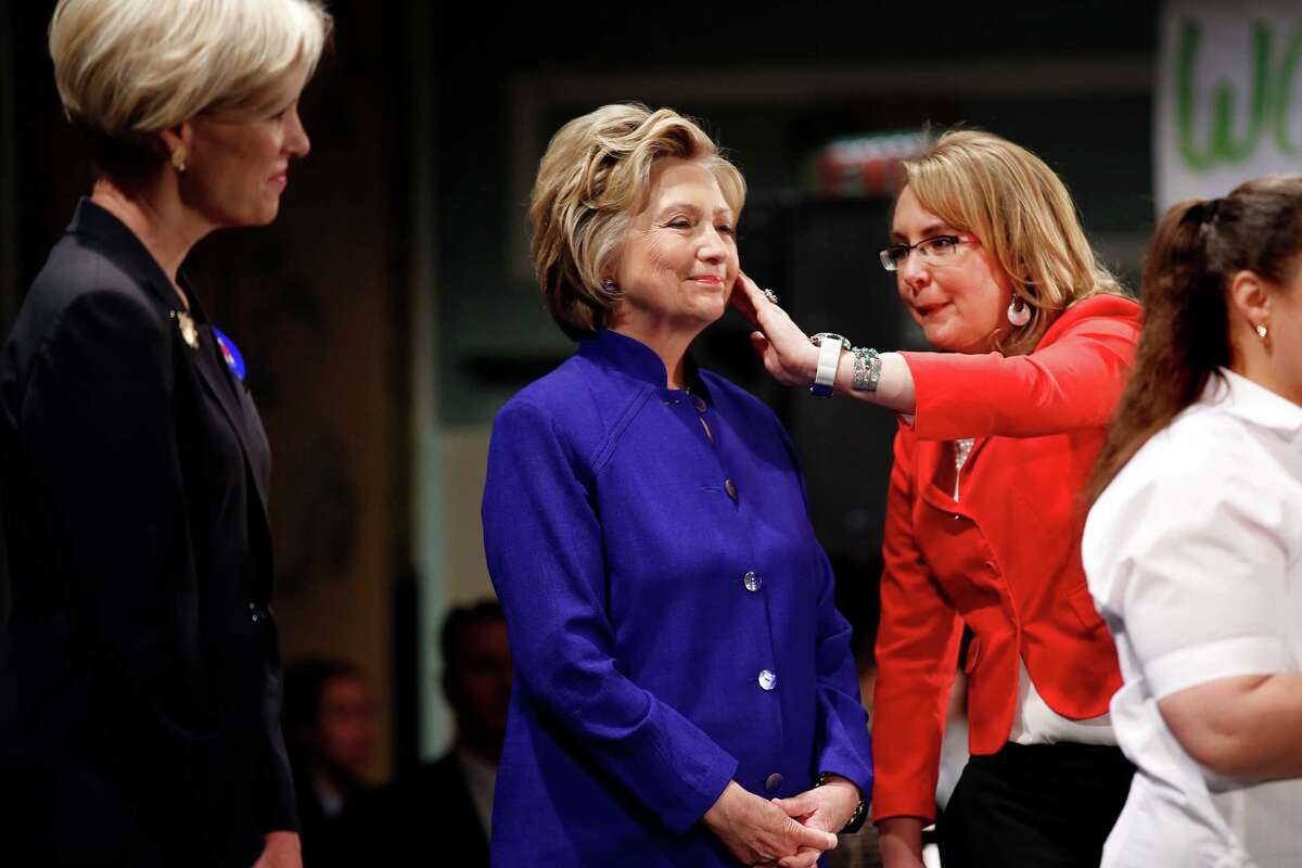 Hillary Clinton stands between Ellen Richards (left), daughter of former Texas Gov. Ann Richards, and former U.S. Rep. Gabrielle Giffords of Arizona at a rally in New York last month.