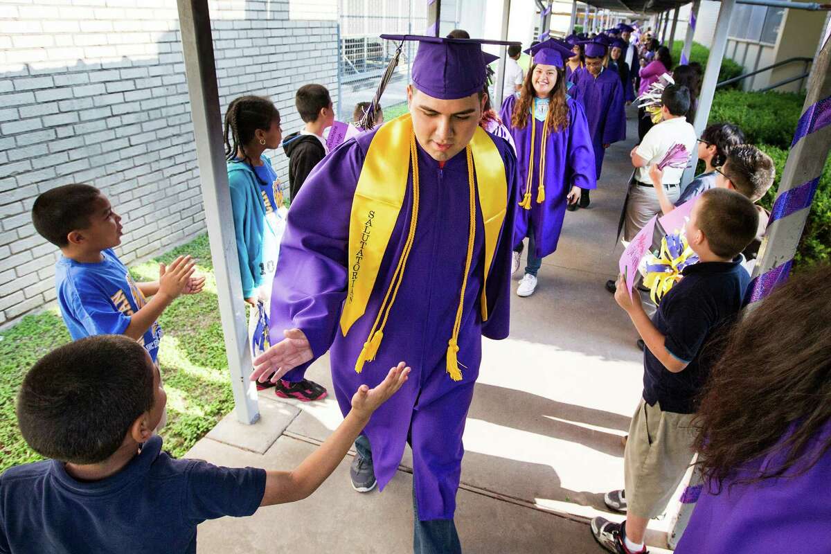 Davis High School graduating seniors get the star treatment May 13 at Looscan Elementary School during the inaugural Senior Walk, which aims to inspire the younger students to stay in school and strive for success. (Brett Coomer / Houston Chronicle )