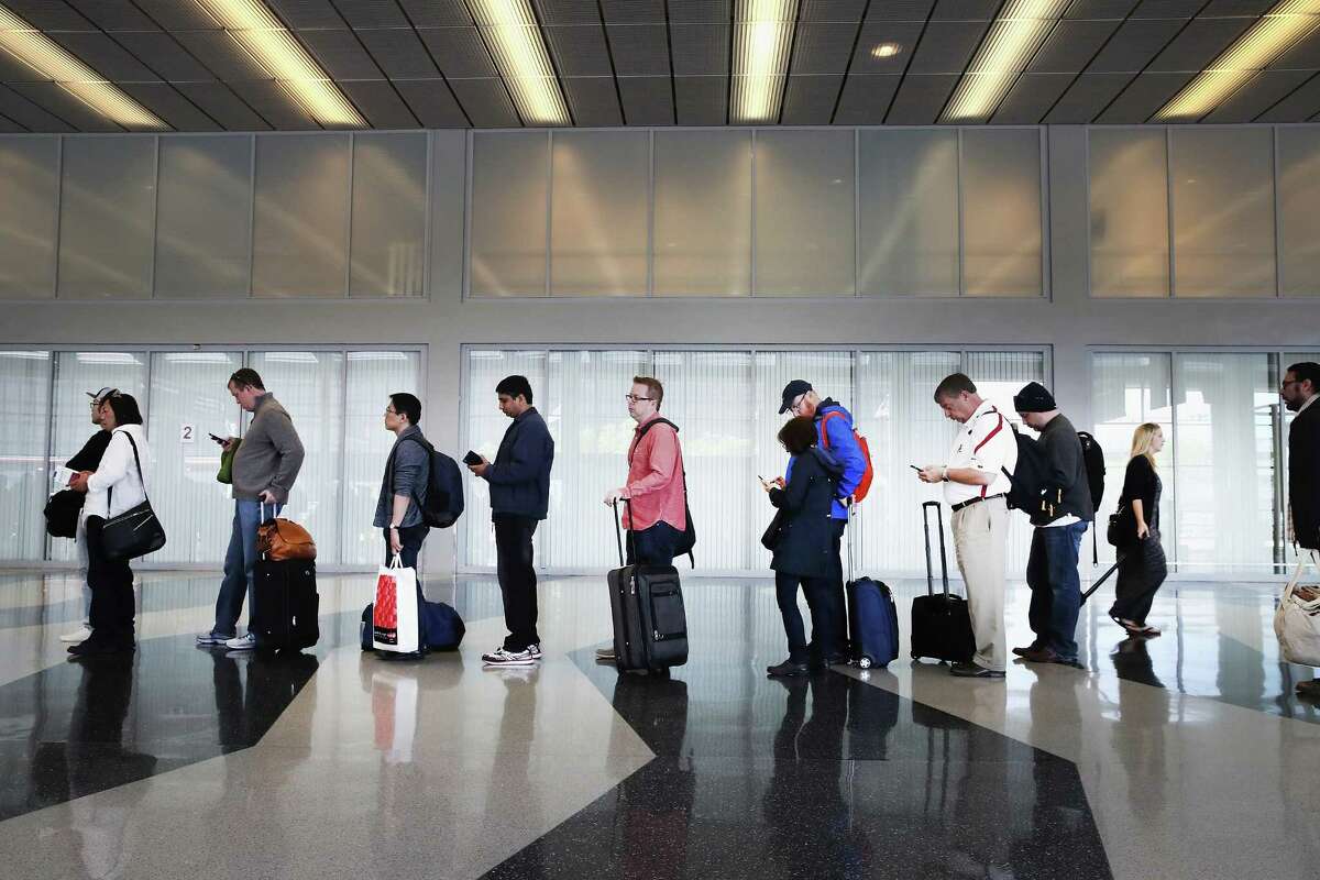 Passengers at Chicago's O'Hare International Airport wait to be screened earlier this week. Airlines say that with the summer bearing down, the TSA is understaffed.