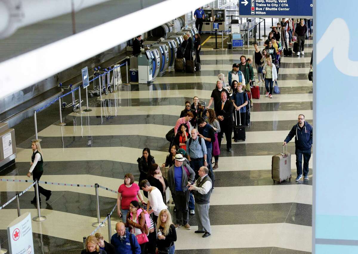 File-This May 16, 2016, file photo shows a long line of travelers waiting for the TSA security check point at O'Hare International airport, in Chicago. As airport security lines get longer, the finger-pointing over blame is growing too. The nation's leading airlines, already feuding with the Transportation Security Administration, are now taking on Congress. The trade group Airlines for America on Thursday, May 19, 2016, says Congress should reverse a 2013 decision that diverted $12.6 billion in passenger-security fees to reducing the federal budget deficit. The airlines want that money to pay for airport security screening. (AP Photo/Teresa Crawford)