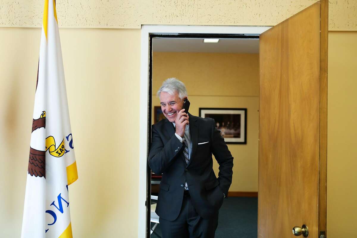 District Attorney George Gasc�n jokes around while pretending to talk on his phone, in the doorway of his office at the Hall of Justice, in San Francisco, California, on Wednesday, May 18, 2016.