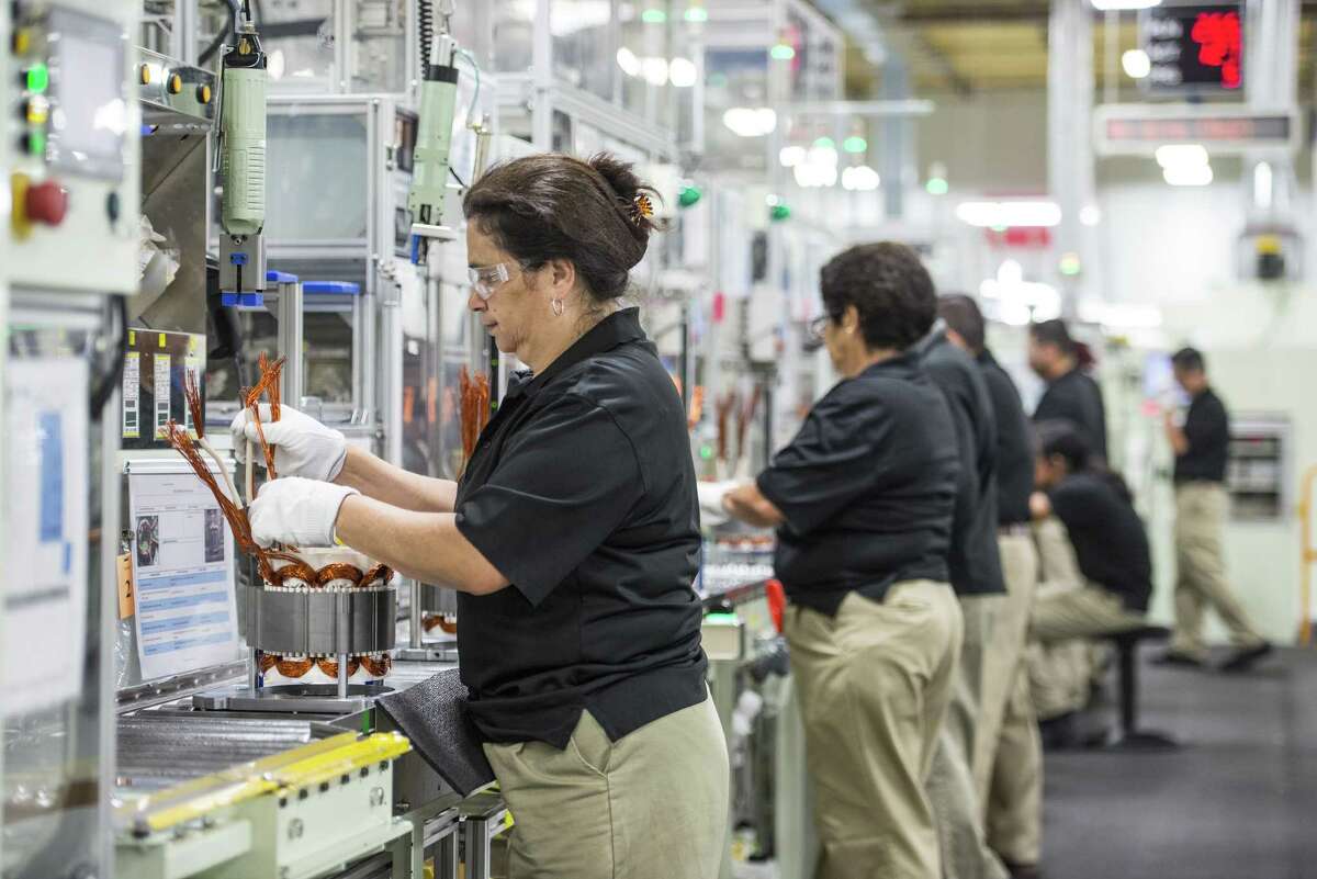 Employees build components for hybrid electric vehicle motors at the Toshiba International Corp. manufacturing facility in Houston. The state’s manufacturing sector, which has suffered from the effect of the high dollar on exports in addition to oil industry cutbacks, lost 4,800 workers in April. Locally, the sector lost 300 jobs.