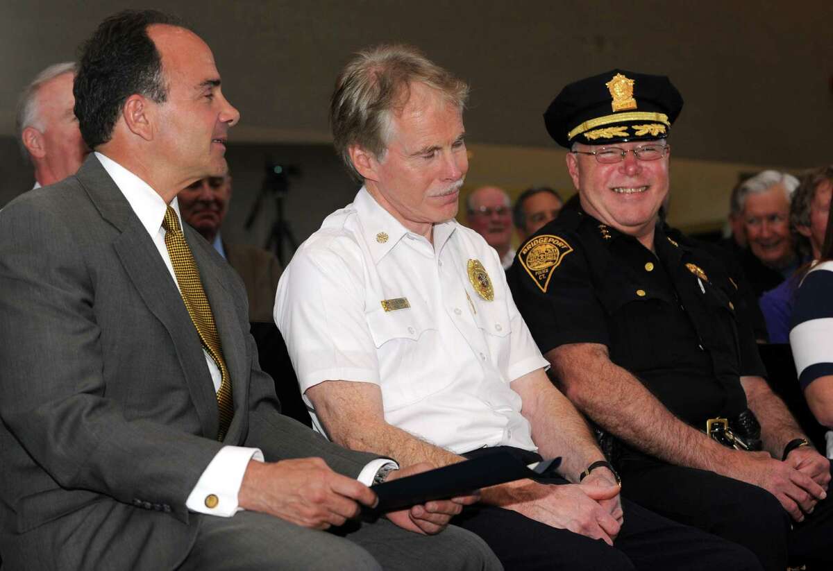 Fire Chief Brian Rooney, seated between Mayor Joe Ganim and Police Chief Armando Perez.