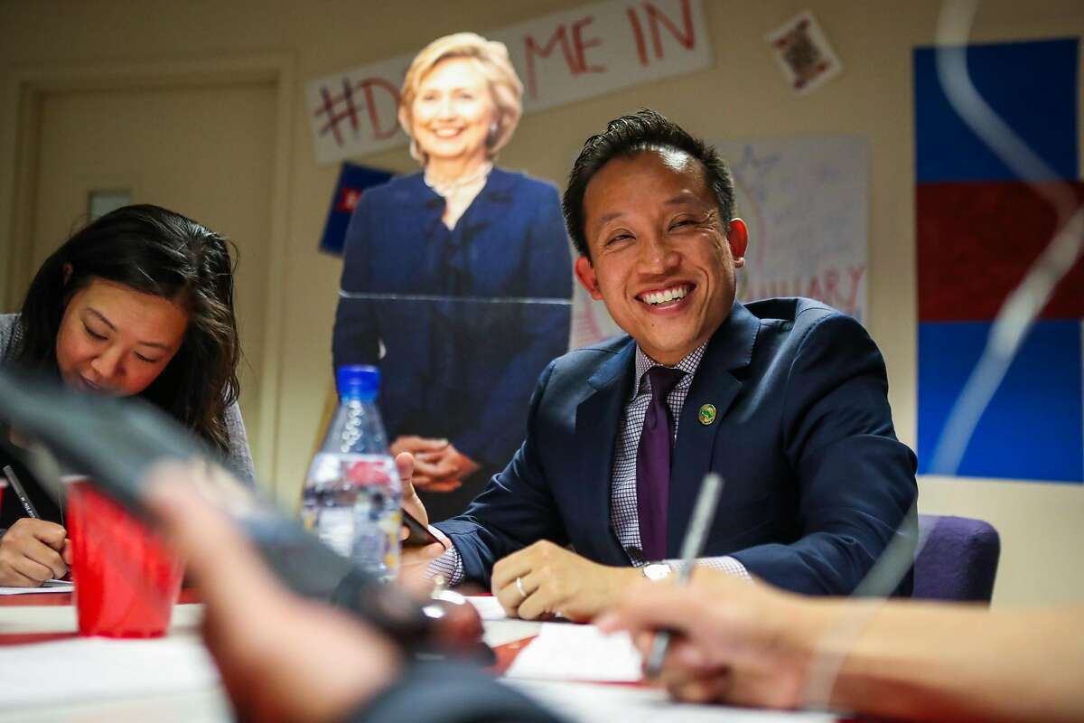 Supervisor David Chiu (center) smiles after making a successful phone call on behalf of presidential candidate Hillary Clinton at her San Francisco office.