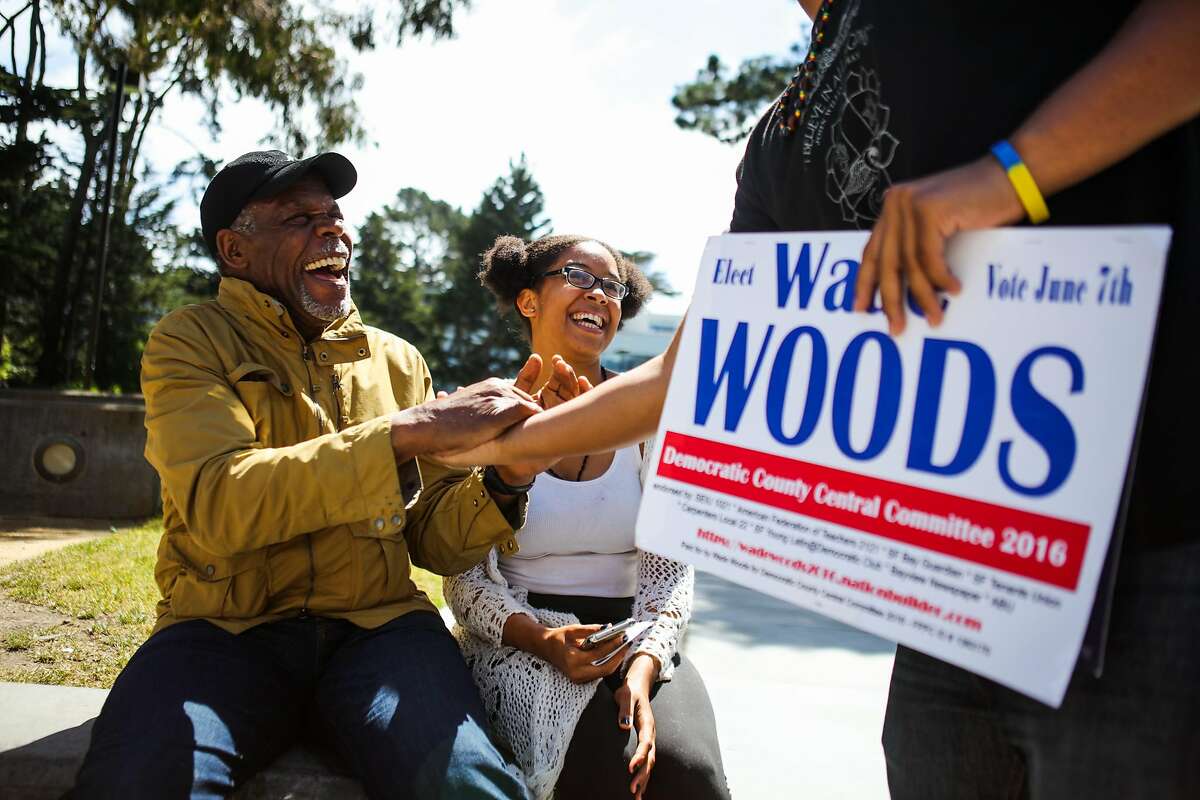 Actor Danny Glover (left) laughs with Larry Dorsey (right) and Alexis Logan (center) after taking a photograph with them during a Bernie Sanders event to get students to register to vote, at San Francisco State University, in San Francisco, California, on Friday, May 20, 2016.