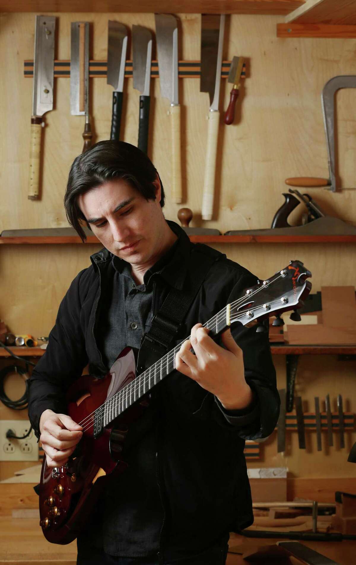 Mike Moreno poses for a portrait the shop of luthier Stephen Marchione Thursday, Feb. 11, 2016, in Houston. Moreno is an alum of the High School for the Performing and Visual Arts. ( Jon Shapley / Houston Chronicle )