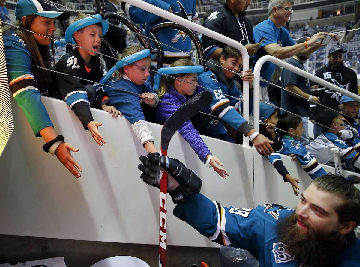 (left to right with balloons on their heads) Cameron Wildt, 9 of San Jose and his 11-year-old twin sisters Elizabeth and Anna greet San Jose Sharks' Brent Burns after warm ups before Sharks' 3-0 win over St. Louis Blues during Game 3 of NHL Playoffs' Western Conference Finals at SAP Center in San Jose, Calif., on, Calif., on Thursday, May 19, 2016.