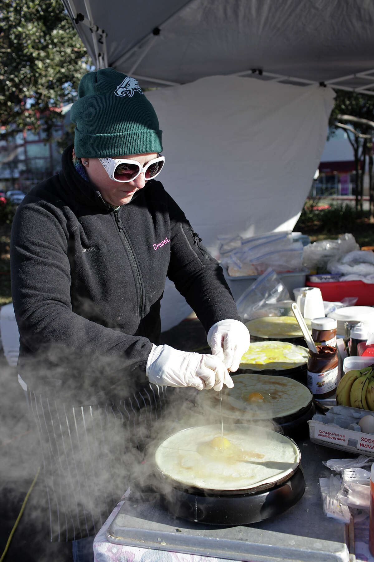 In this 2013 photo, chef Marissa Schaeffer cooks up crepes at the Good Gluten Free Foods booth at the now-defunct Alamo Quarry Farmer's Market. A new regulation passed in October added a new fee to vendors cooking or warming up food at San Antonio’s farmers markets.