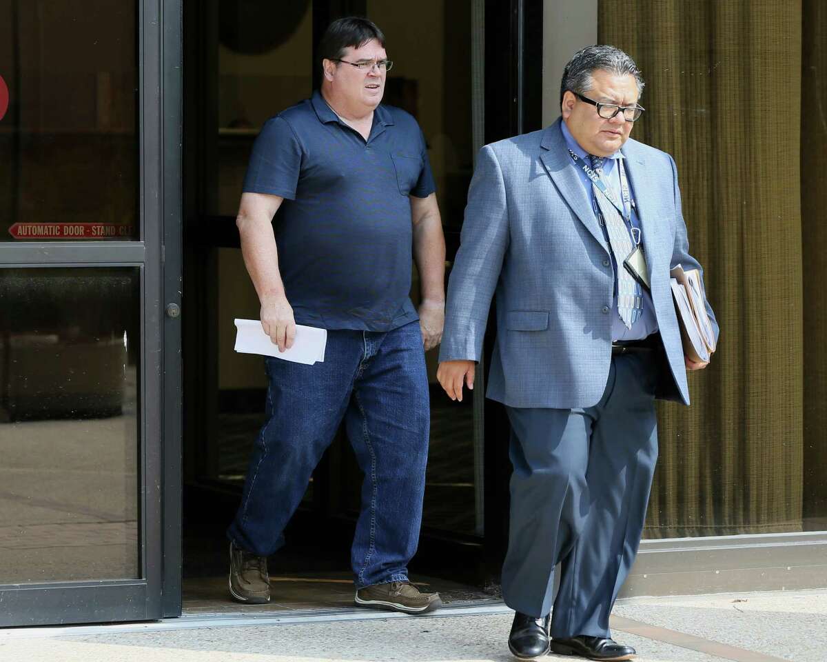 Theodore De Aubrey (left), 57, a former math teacher at La Vernia High School, leaves the federal courthouse after being released on bond on Friday, May 20, 2016. De Aubrey was indicted on federal child pornography charges.