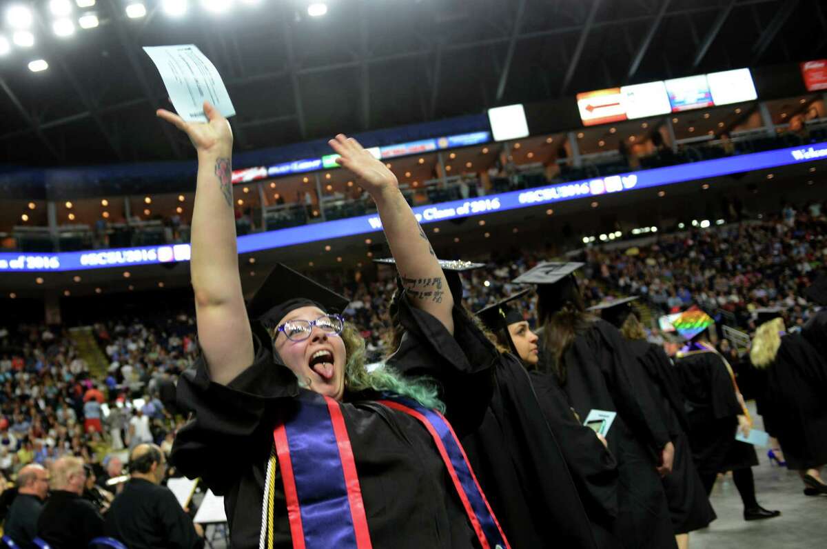 Above, Cori Kelemencky, of Woodbury, waves to her family at the start of Southern Connecticut State University's Commencement 2016 Undergraduate Ceremony at the Arena at Harbor Yard in Bridgeport on Friday.