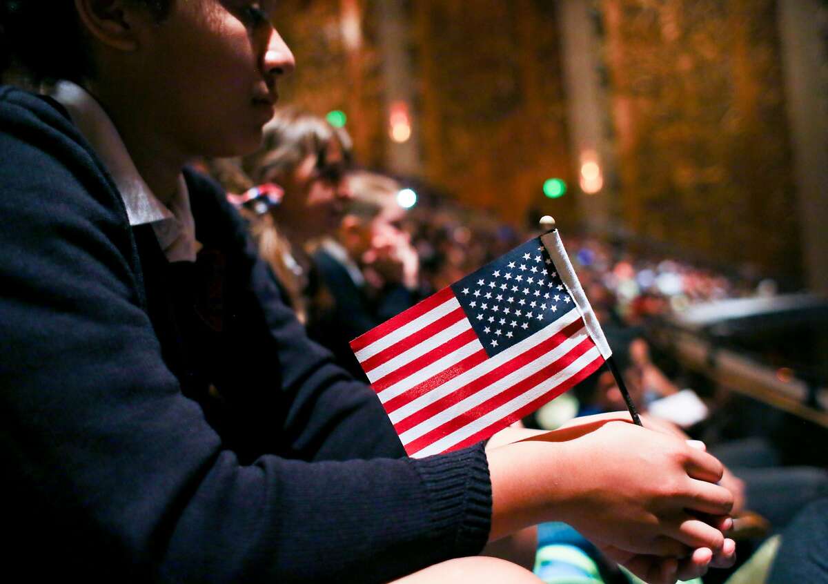 Fetutuki Havili, 11, watches a naturalization ceremony along with other students from St. Philip the Apostle in San Francisco at the Paramont Theater in Oakland on Wednesday, May 18, 2016. Their teacher Mary McKeever spoke as the key note speaker at the ceremony. Brian Feulner, Special to the Chronicle