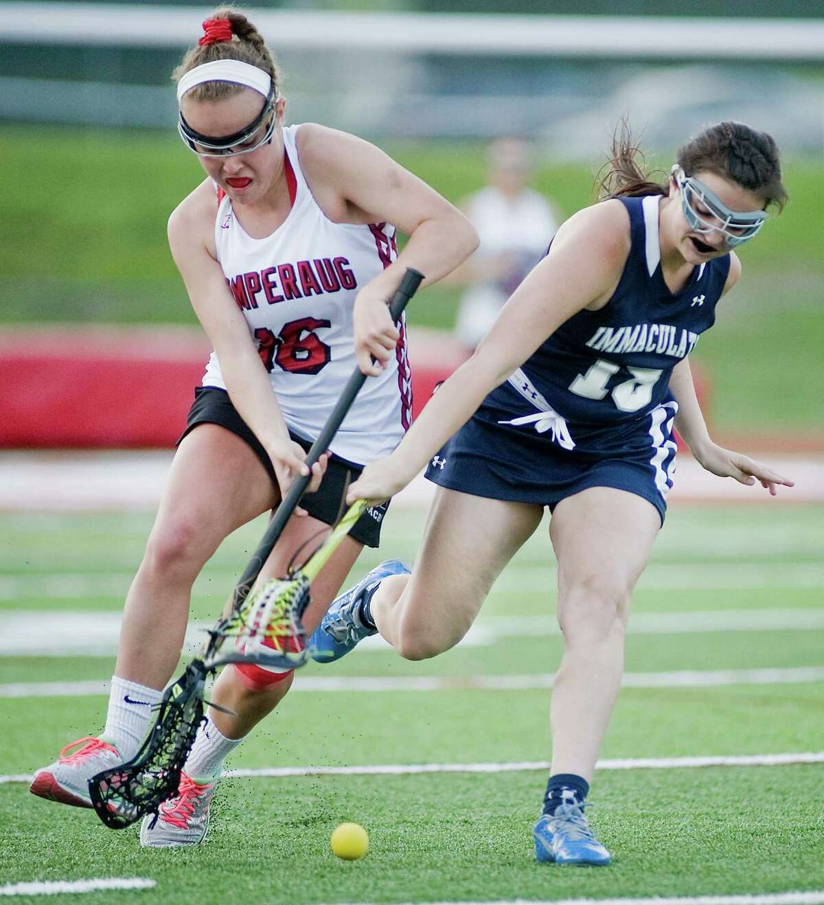 FILE PHOTO: Pomperaug High School's Hayley McCormick and Immaculate High School's Madeleine Wedvik fight for the ball during a game at Pomperaug. Tuesday, May 10, 2016