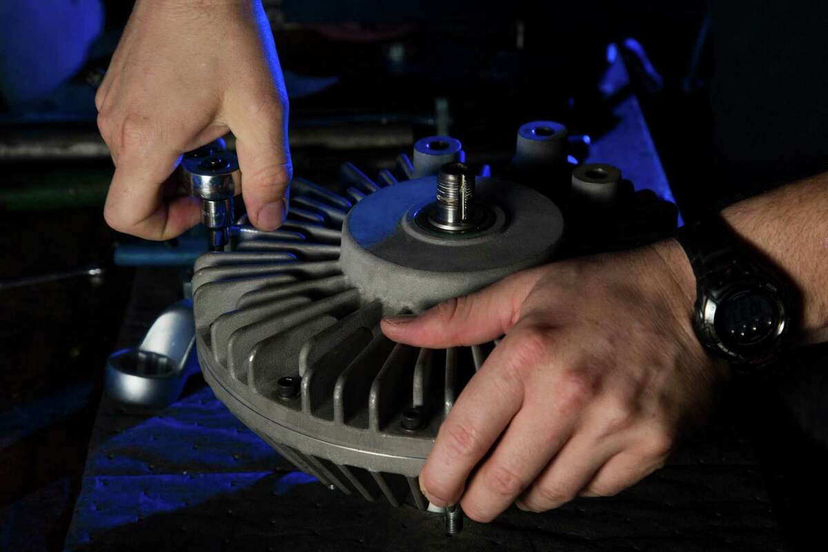 Joe Bivona, Orbital Traction test engineer, assembles a fan drive, Thursday, May 19, 2016, in Houston. Orbital Traction makes devices that reduces diesel emissions when added to truck engines. ( Marie D. De Jesus / Houston Chronicle )