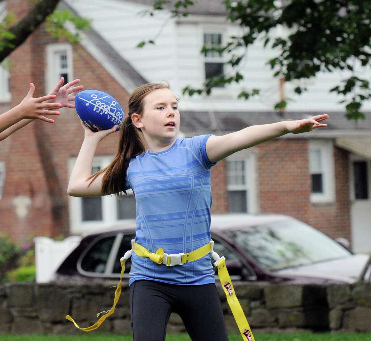 Erin Morlock, 12, plays quarterback during the Chargers flag football practice at Pemberwick Park in the Pemberwick section of Greenwich, Conn., Saturday, May 21, 2016. Charger coaches Tim Harkness and Jim Morlock, said the team is part of the Greenwich Flag Football League that plays their games at Greenwich High School against other teams from the area.