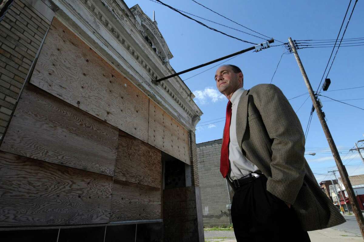 Schenectady City Zoning Officer Steven Strichman stands in front of a boarded up building on Albany Street on Thursday Aug. 11, 2011 in Schenectady, NY. The building is one of 185 properties the city will soon take through foreclosure. The properties will then be put in a land bank, a nonprofit entity that allows the city to keep taxes from sold properties for demolition or future property maintenance.(Philip Kamrass / Times Union)