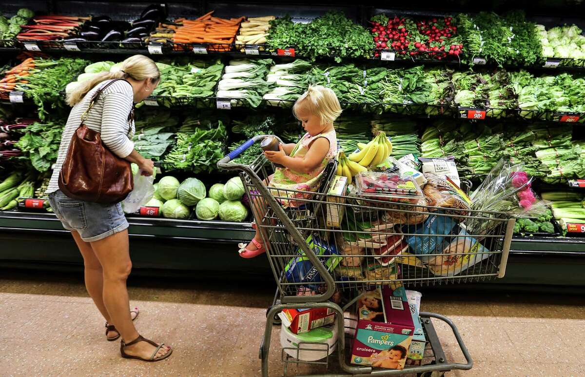 Anne Goss buys produce with her 18-month-old daughter, Stella, at the Kroger Store on Buffalo Speedway on Friday, May 20, 2016, in Houston. The store is one of Houston Chronicle's top 100.