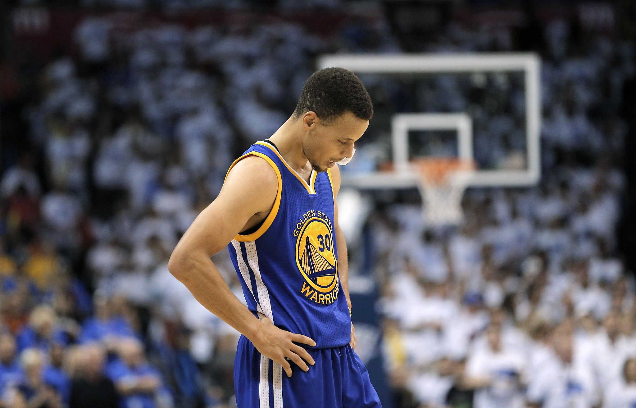 Golden State Warriors guard Stephen Curry wipes his face during a