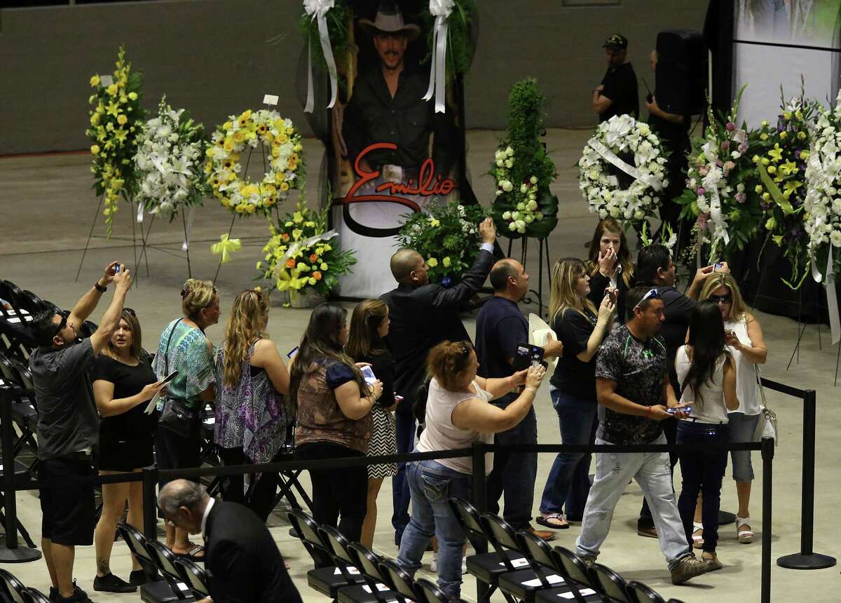 People take photographs as they line up to pay respects during a visitation and rosary for Tejano music superstar Emilio Navaira at the Freeman Coliseum, Sunday, May 22, 2016. Navaira died suddenly at his home in New Braunfels on May 16. Tens of thousands were expected to pay their respects during the viewing. A rosary was planned to 4 p.m.