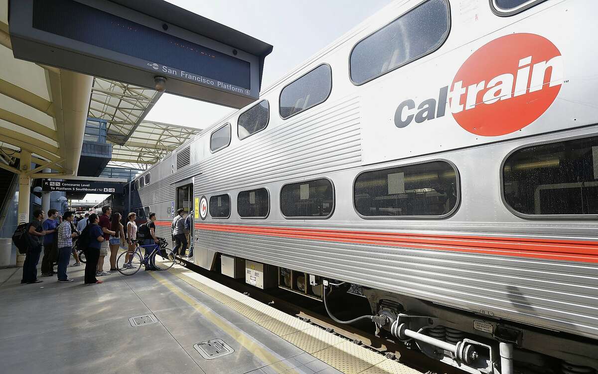 Commuters board a Caltrain train at the Caltrain and Bay Area Rapid Transit station in Millbrae, Calif., Monday, July 1, 2013.