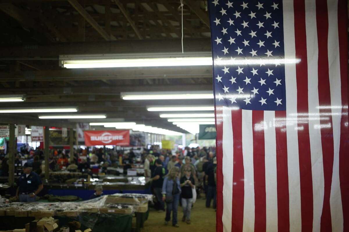 An American flag hangs from the rafters during the Fall 2015 Knob Creek Machine Gun Shoot in West Point, Kentucky, U.S., on Friday, Oct. 9, 2015. "Barack Obama is single handily responsible for the sales of more guns and ammo than any human being in the history of the United States," said Richard Feldman, a former NRA political organizer. Hillary "Clinton could do better." MUST CREDIT: Bloomberg photo by Luke Sharrett.