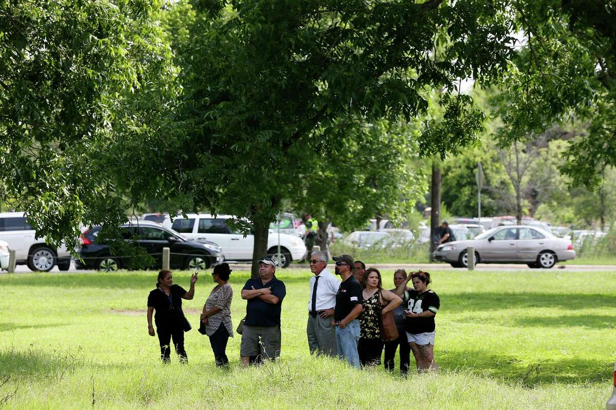Fans gather under the shade of a tree in a field next to San Juan Cementery as Tejano music superstar Emilio Navaira, III, is laid to rest in Berg's Mill, Monday, May 23, 2016. The funeral mass will be at San Fernando Cathedral. Navaira, 53, died suddenly on May 16 at his home in New Braunfels.