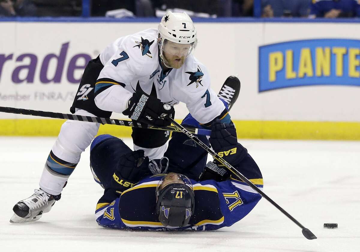 San Jose Sharks defenseman Paul Martin (7) chases the puck against St. Louis Blues left wing Jaden Schwartz (17) during the second period in Game 5 of the NHL hockey Stanley Cup Western Conference finals, Monday, May 23, 2016, in St. Louis. (AP Photo/Jeff Roberson)