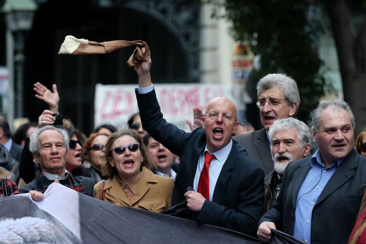 A lawyer waves his tie as others shout slogans during a protest earlier this year in Athens. Greek lawyers have been on strike for months against austerity measures that impose heavy taxes on self-employed professionals.﻿