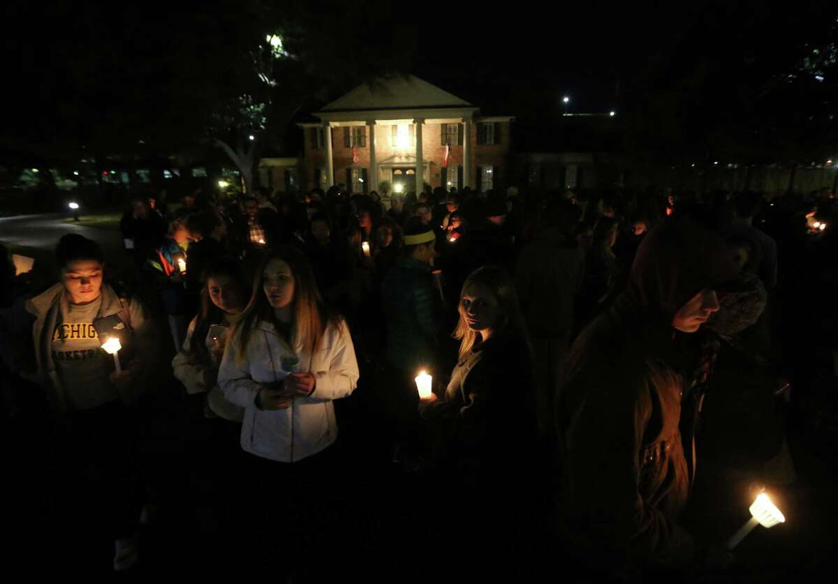 FILE - In this Monday, Feb. 8, 2016 file photo, Baylor students and alumni hold a candlelight vigil outside the home of Baylor University President Ken Starr in what organizers' call a "Survivors' Stand" in Waco, Texas. The event was held in an effort to urge changes to how the school handles sexual assault. The university did not report a single instance of sexual assault in a four-year span, according to federal statistics, a finding that represents a sharp contrast to multiple reports at two smaller private schools in Texas over the same period.