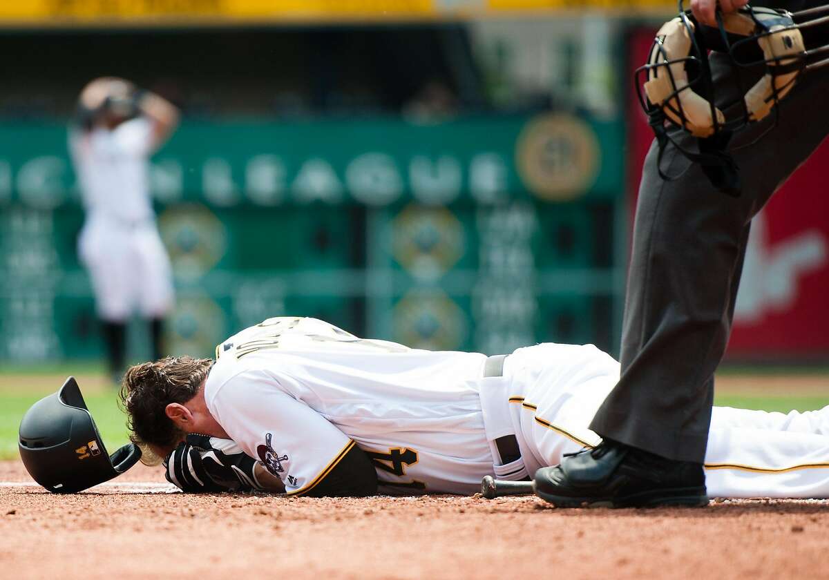 PITTSBURGH, PA - MAY 23: Ryan Vogelsong #14 of the Pittsburgh Pirates lays on the ground after being hit in the head by a pitch thrown by Jordan Lyles #24 of the Colorado Rockies in the second inning during the game at PNC Park on May 23, 2016 in Pittsburgh, Pennsylvania. (Photo by Justin Berl/Getty Images) ***BESTPIX***