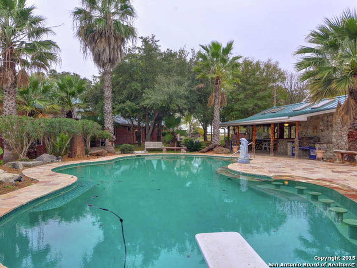 This 18-acre property in New Braunfels includes a six-bedroom home, a Keith Zars pool with a swim-up bar, a pond, a guest home and a greenhouse. The foreclosure is listed at $1.25 million.