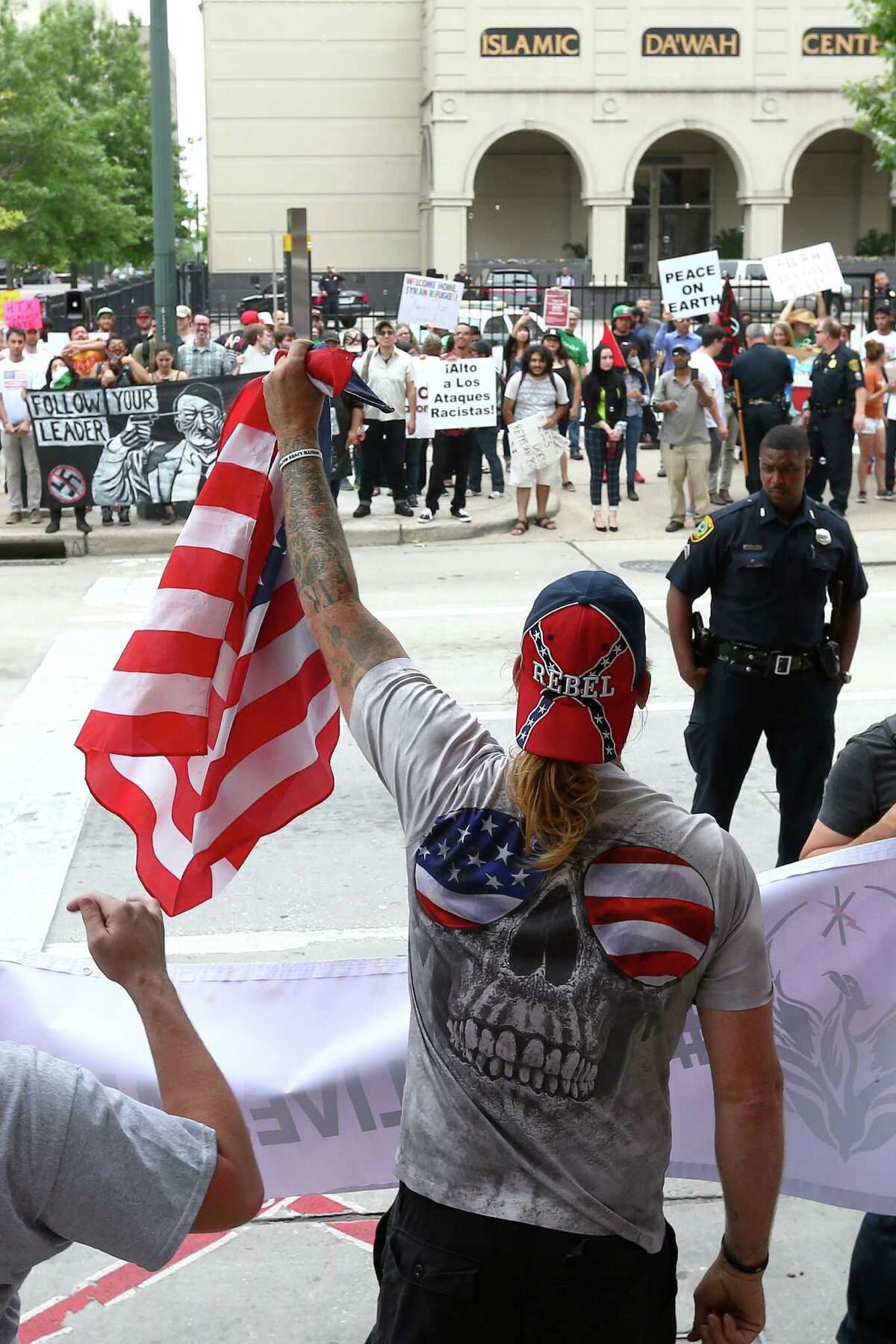 "Show me your patriotism," a protester who referred to himself as "Doug," center, yells at counter-protesters at the Islamic Da'Wah Center, Saturday, May 21, in Houston. "Equality and social justice aren't necessarily a bad thing, but they don't have the interests of the Houston community in mind," he said. "This is the U.S., not Saudi Arabia. This doesn't have anything to do with Texas social justice." ( Jon Shapley / Houston Chronicle )