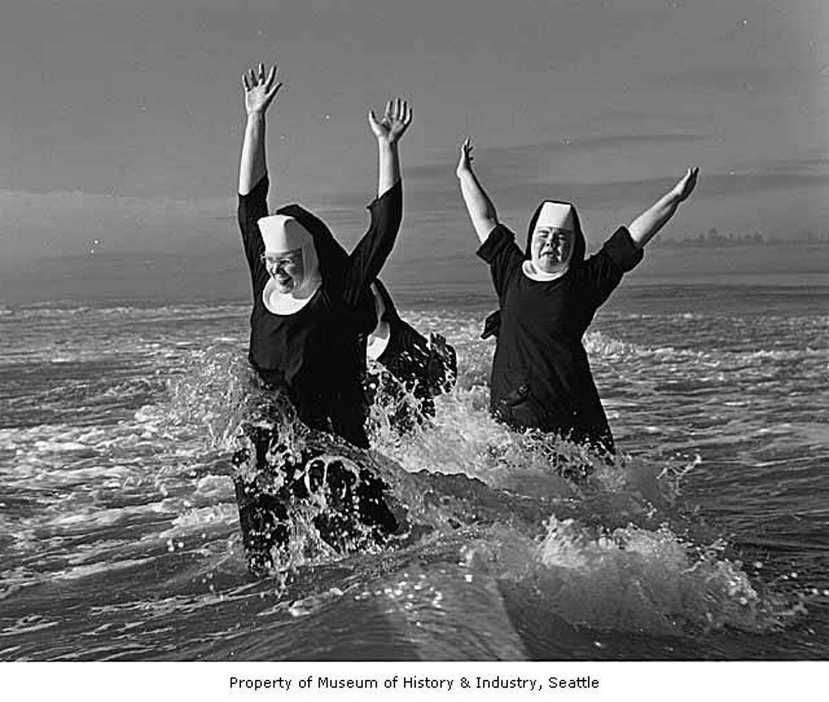 "A group of nuns from the Order of Saint Benedict enjoyed their summer vacation at the beach in Grayland. Here Sisters Ruth (left) and Agnes play in the surf; partly hidden is Sister Rita. After a weeklong break they returned "refreshed and strengthened" to their routine duties of teaching school in the Seattle and Tacoma area." -MOHAI. Photo, dated Aug. 21, 1960, courtesy MOHAI, Seattle P-I Collection, image number 1986.5.6047.