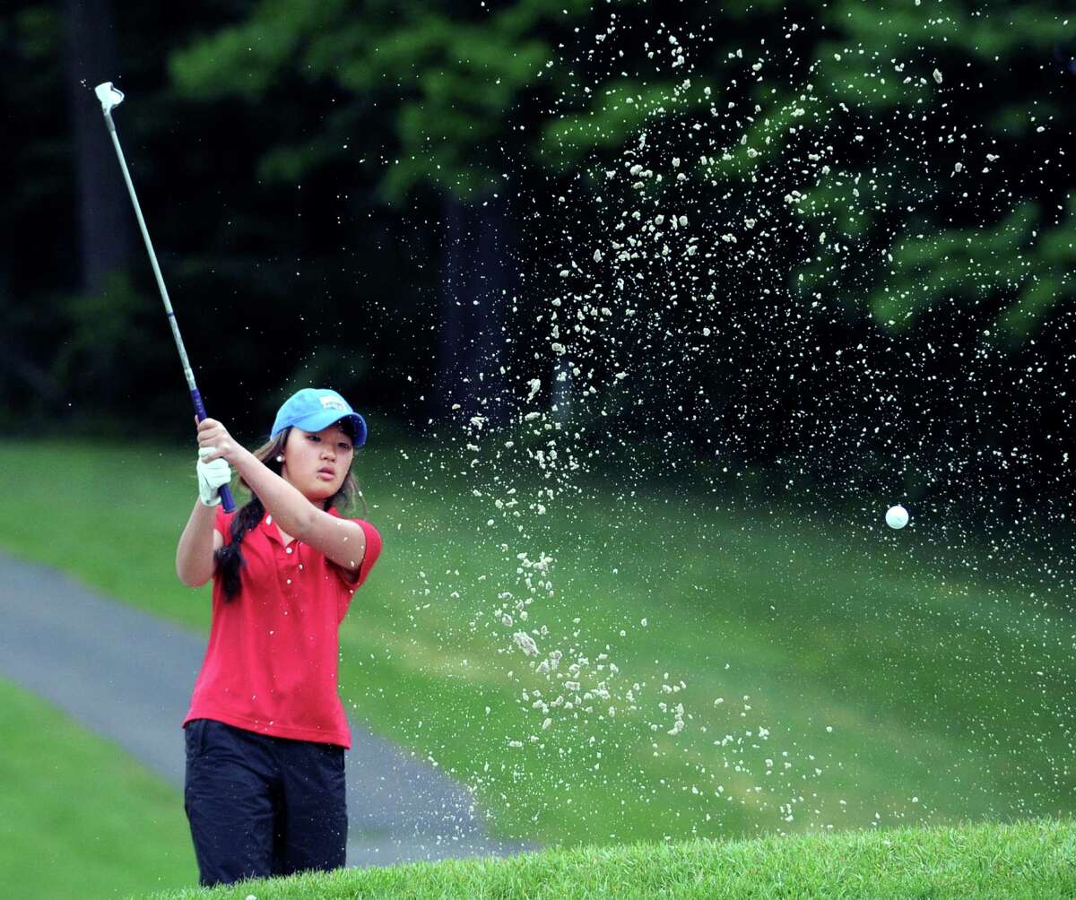 Grace Sunoo of Greenwich shoots out of a bunker near the second green during Tuesday’s match against Staples at the Griffith E. Harris Golf Course in Greenwich.