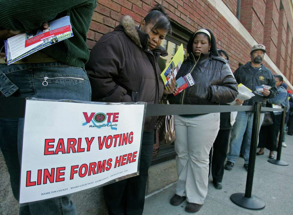 FILE - In this Oct. 29, 2008 file photo, voters line up outside the Hamilton County Board of Elections for early voting in Cincinnati. U.S. District Judge Michael Watson ruled Tuesday, May 24, 2016, that a law trimming early voting in Ohio is unconstitutional, after the state's Democratic Party and other plaintiffs sued over Republican-backed changes to voting rules in the presidential battleground state. (AP Photo/Al Behrman, File)