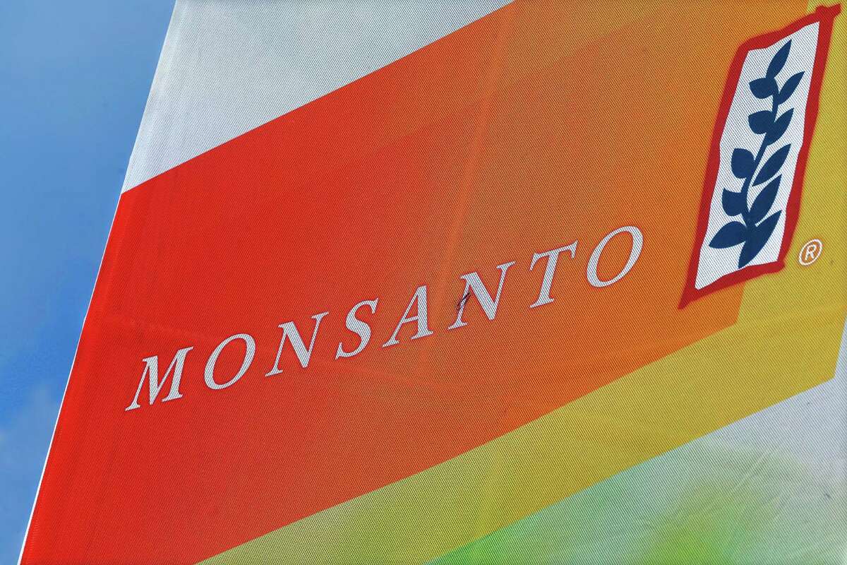 FILE - This Aug. 31, 2015, file photo, shows the Monsanto logo seen at the Farm Progress Show in Decatur, Ill. Monsanto is rejecting Bayer's $62 billion takeover bid, calling it "incomplete and financially inadequate. However, the seed company suggested Tuesday, May 24, 2016, that a higher bid might be accepted, saying that it remains open to talks. (AP Photo/Seth Perlman, File)