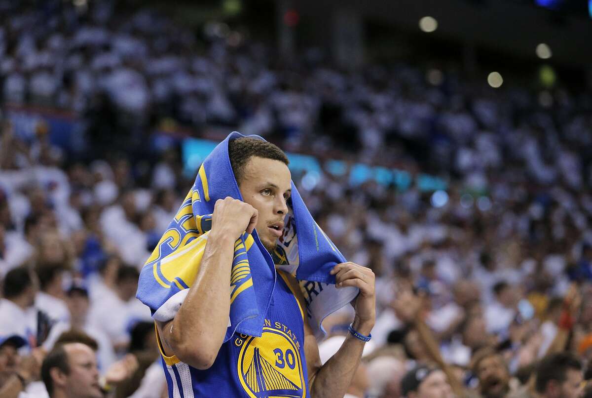 Stephen Curry (30) puts a towel on his head as he takes a seat on the bench in the final minutes of the second half as the Golden State Warriors played the Oklahoma City Thunder in Game 4 of the Western Conference Finals at Chesapeake Energy Arena in Oklahoma City, Okla., on Tuesday, May 24, 2016. The Thunder defeated the Warriors 118-94, to take a 3 games to 1 lead.