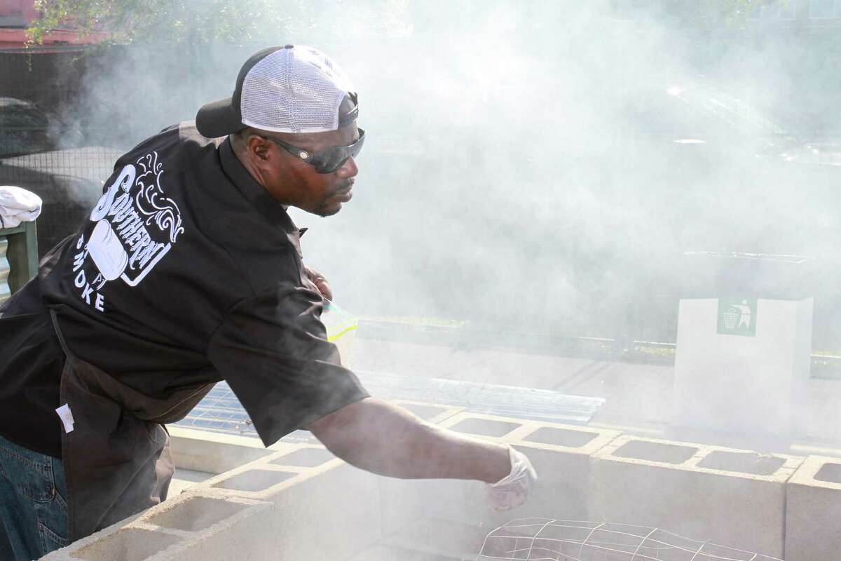Rodney Scott seasoning a whole hog at 2015 Southern Smoke, a huge barbecue event sponsored by Underbelly.