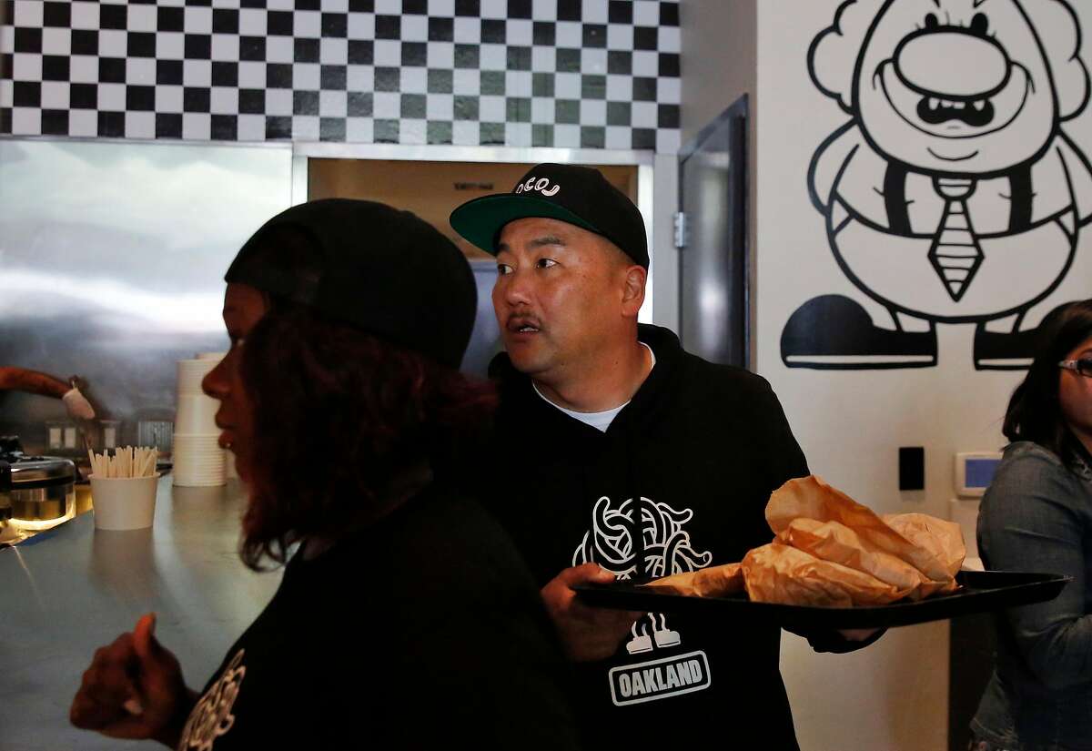 Co-founder and Chef Roy Choi takes food to his staff during the opening day of LocoL, which offers affordable and healthy fast food May 25, 2016 in Oakland, Calif. Chefs Roy Choi and Daniel Patterson are co-founders of the restaurant.