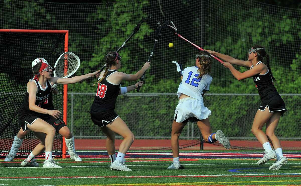 Darien Susannah Ropp fires the winning goal shot against New Canaan goal keeper Cameron Blair in a FCIAC Girls Lacrosse Final at Brien McMahon High School in Norwalk, Conn. on May 26, 2016. Darien defeated New Canaan 12-11 in over-time.