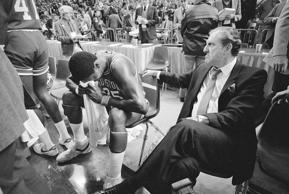 PHOTOS: See what the NCAA Tournament bracket looked like in 1984 Hakeem (then Akeem) Olajuwon (35) buries his head in a towel and cries after the Cougars of Houston lost their NCAA national title to Georgetown, 84-75, in Seattle, April 2, 1984. At right, coach Guy Lewis looks on.