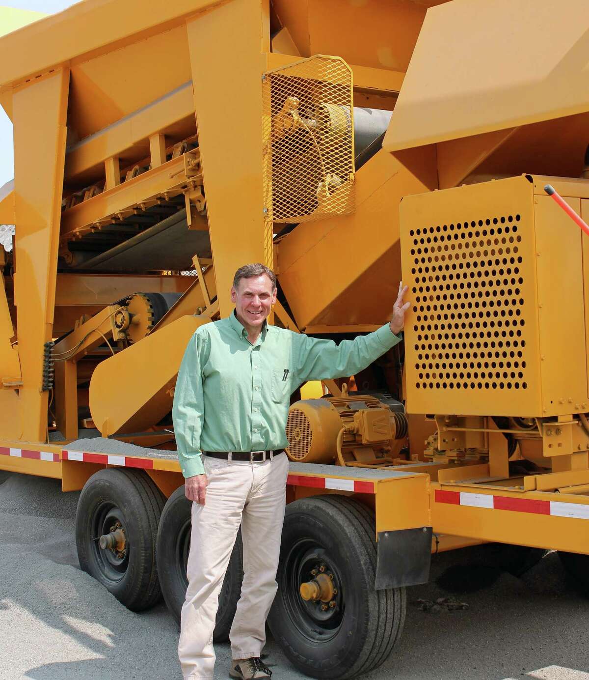 Public Works Superintendent Scott Bartlett celebrates his 35th year with the town this August. Here, he stands in front of some of the equipment used to pave and maintain the town's roads.