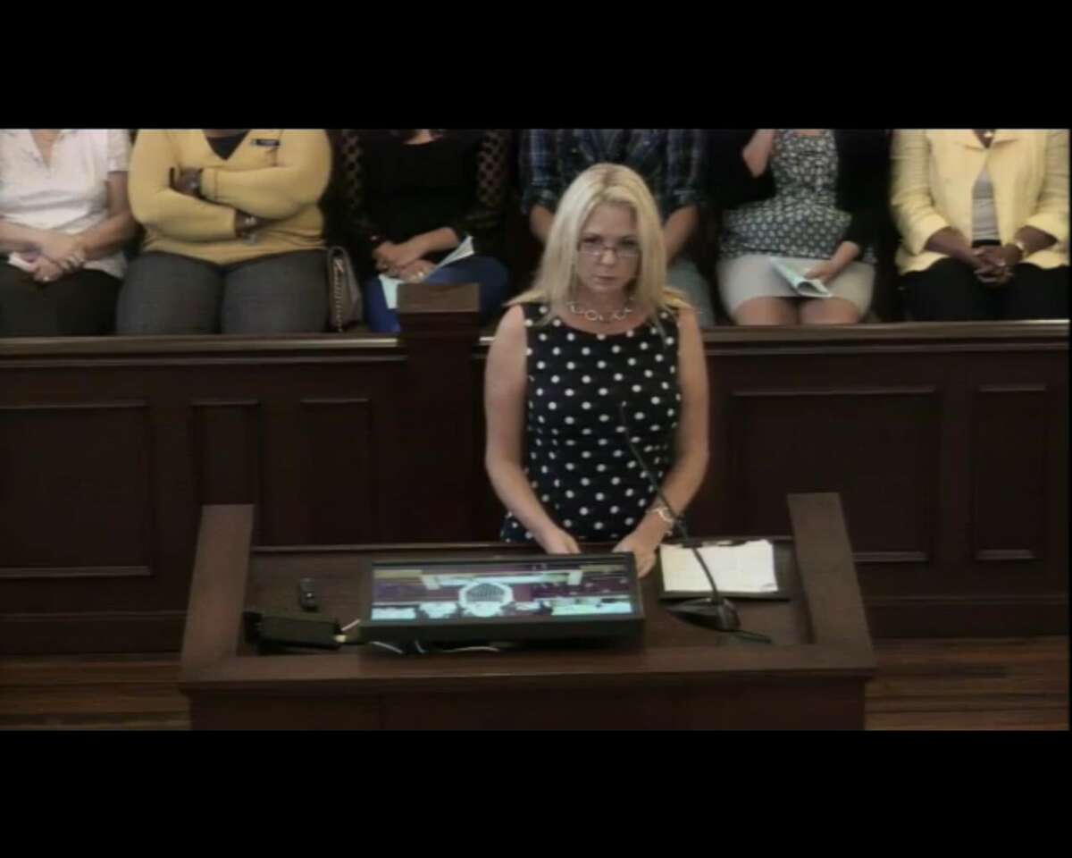 Renae Henze, the widow of a soldier who committed suicide in 2013, addresses Bexar County Commissioners Court on Tuesday, May 17, during the court's annual Memorial Day observance. Henze was backed by a delegation from Joint Base San Antonio's Survivor Outreach Services.