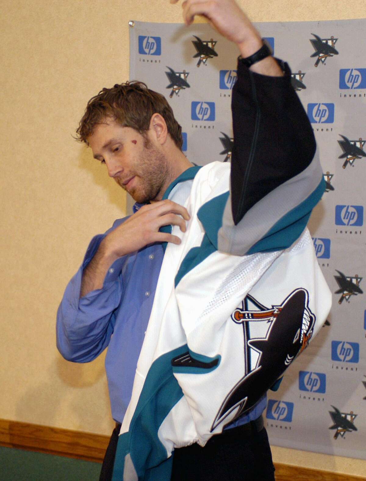 Joe Thornton tries on a San Jose Sharks jersey during a news conference in Buffalo, N.Y. on Thursday, Dec 1, 2005. The Boston Bruins traded Thornton to the Sam Jose Sharks for forwards Marco Sturm and Wayne Primeau and defenseman Brad Stuart.(AP Photo/Don Heupel) Ran on: 12-02-2005 Ran on: 12-02-2005