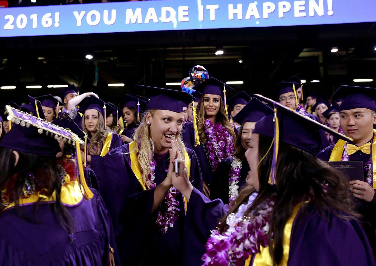 Jillian Sobol high fives fellow student as they collect their college diplomas during their SFSU graduation ceremony at AT&T Park on Fri. May 27, 2016, in San Francisco , California. Sobol was found abandoned as a baby in 1984 on the campus San Francisco State University.