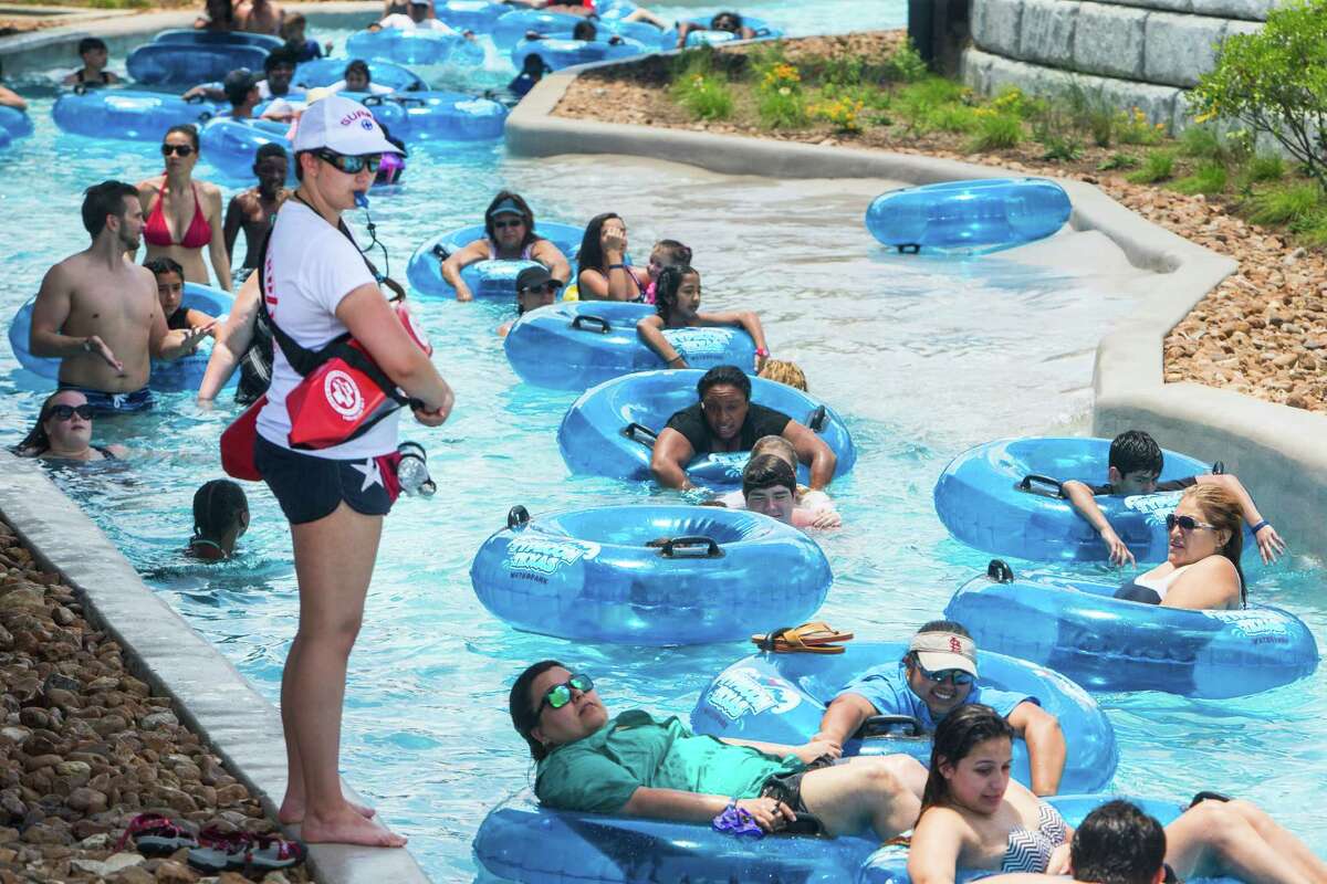 Visitors to Typhoon Texas water park float along the "Lazy T" river during the grand opening of the park on Saturday, May 28, 2016, in Katy.