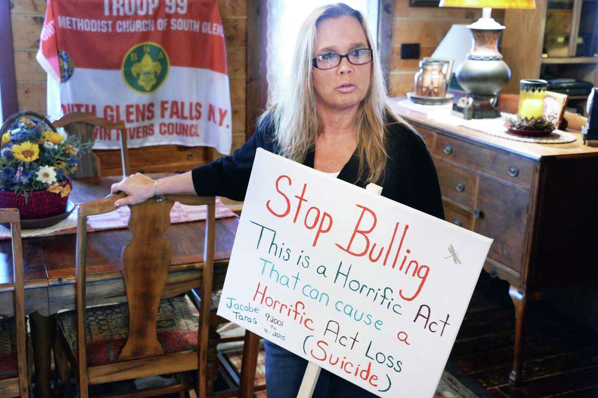 Christine Taras holds a Stop Bullying sign during an interview at her home Friday, May 6, 2016, in Fort Edward, N.Y. Her son Jacobe Skyler Taras killed himself at the age of 12. (John Carl D'Annibale / Times Union)