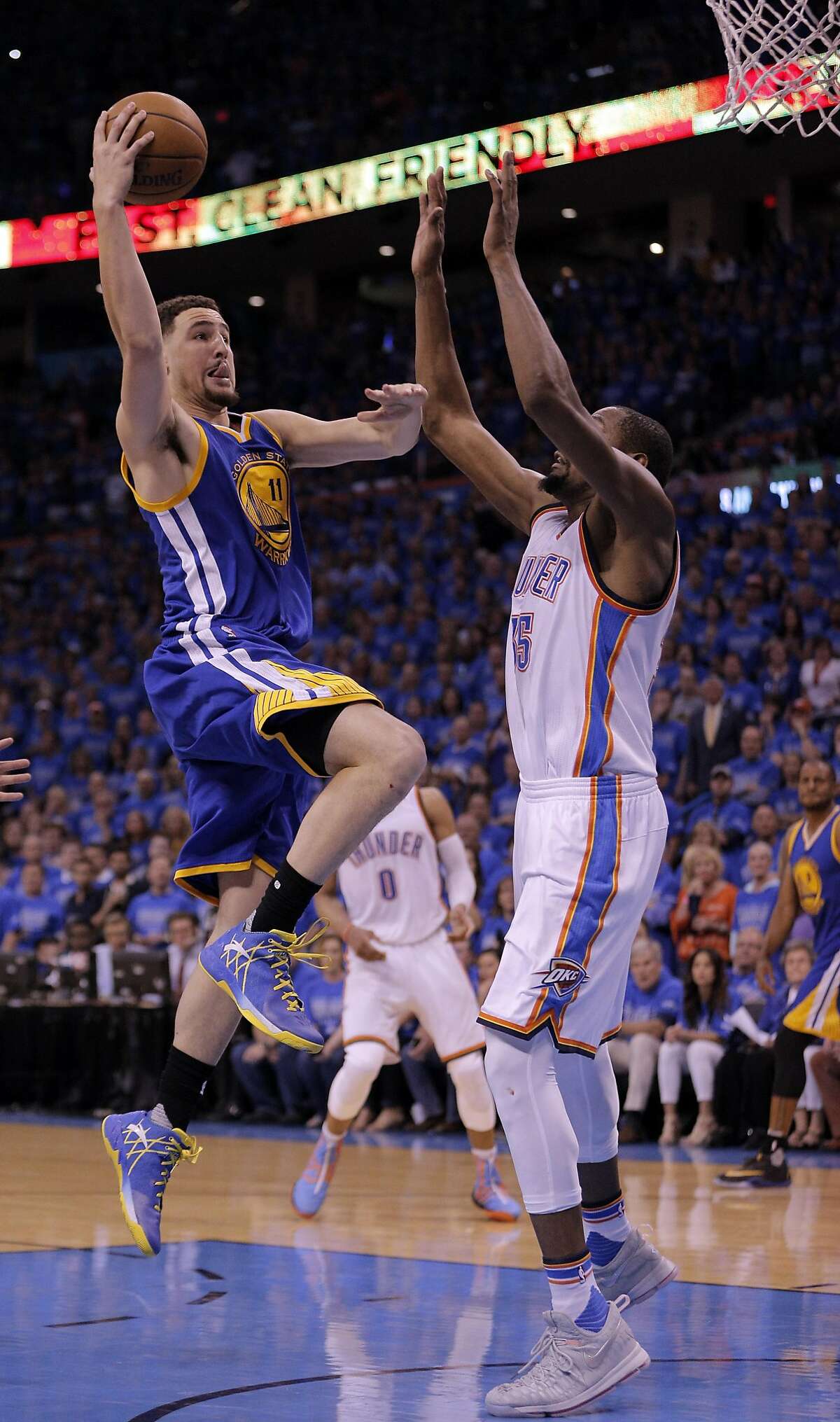 Klay Thompson (11) shoots over Kevin Durant (35) in the second half as the Golden State Warriors played the Oklahoma City Thunder in Game 6 of the Western Conference Finals at Chesapeake Energy Arena in Oklahoma City, Okla., on Saturday, May 28, 2016.