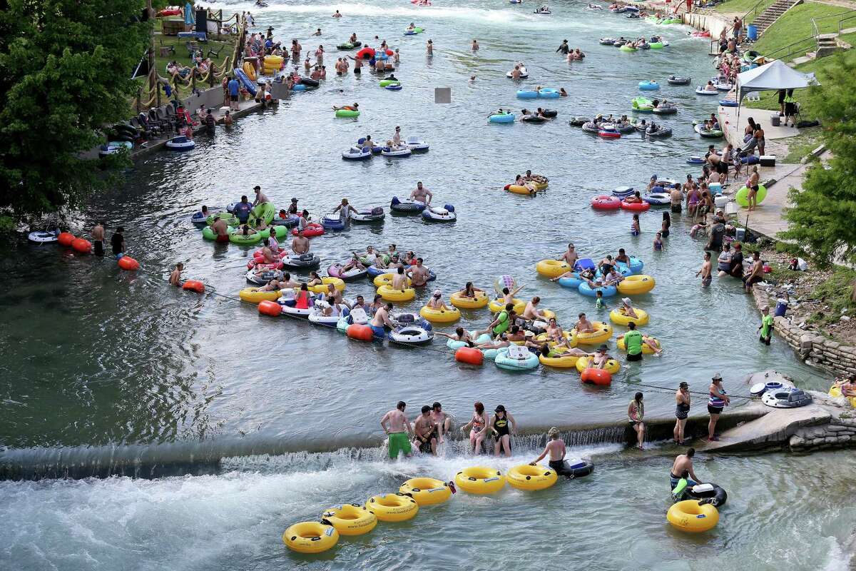 People enjoy the tube chute area in Prince Solms Park on the Comal River in 2016 in New Braunfels.